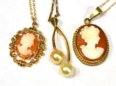 Lot 393 - A cultured pearl pendant stamped ";14K"; on a 9ct gold chain, two cameo pendants on chains