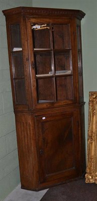 Lot 431 - A late 18th/early 19th century fruitwood floor standing corner cabinet with glazed upper section