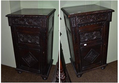 Lot 453 - Pair of carved oak cupboards