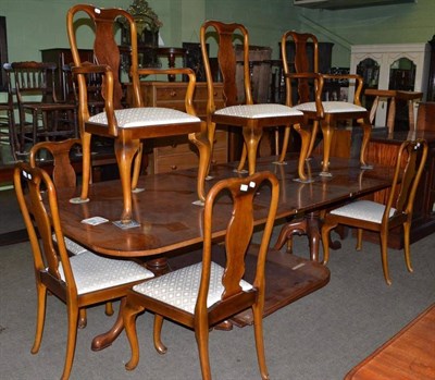 Lot 464 - Walnut pedestal table and a set of eight walnut chairs