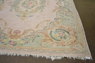 Lot 492 - An Indian carpet of Savonnerie design, the field centred by a floral medallion framed by mint green