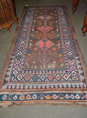 Lot 495 - Kurdish rug, the walnut field with three medallions enclosed by multiple borders, 267 by 123cm...