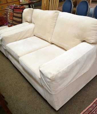 Lot 509 - A pair of cream upholstered two seater sofas, 140cm x 70cm x 95cm