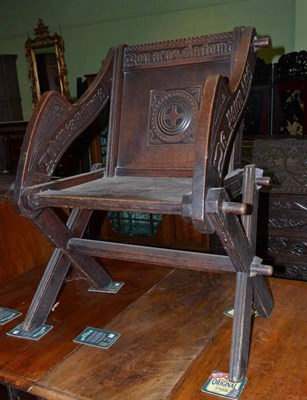 Lot 522 - A ecclesiastical carved oak armchair