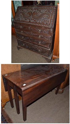 Lot 528 - Carved oak bureau and a mahogany drop leaf table