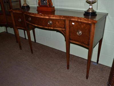 Lot 556 - An early 19th century serpentine fronted mahogany sideboard