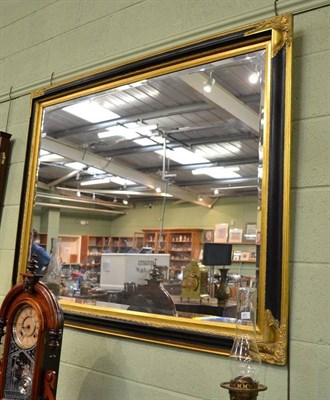 Lot 561 - Large black and gilt reproduction mirror