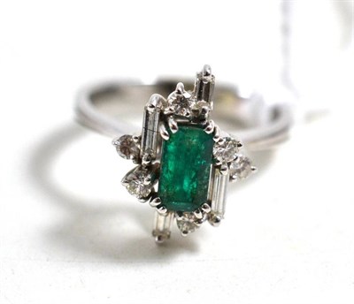 Lot 18 - An emerald and diamond cluster ring