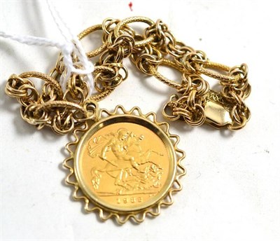 Lot 31 - A 9ct gold fancy link bracelet hung with a 1982 half sovereign
