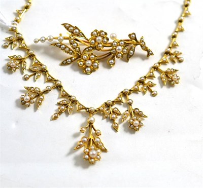 Lot 38 - A pearl set necklace stamped '15ct' and a matching floral spray brooch