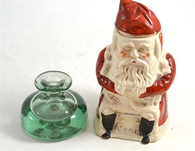 Lot 87 - A tobacco jar of Father Christmas and a glass inkwell