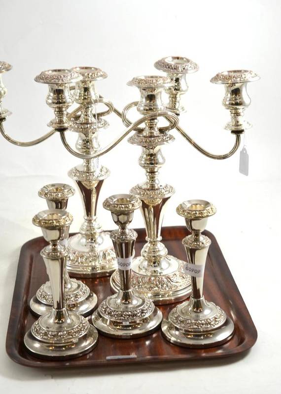 Lot 88 - A pair of plate on copper candlesticks and four small plated candlesticks