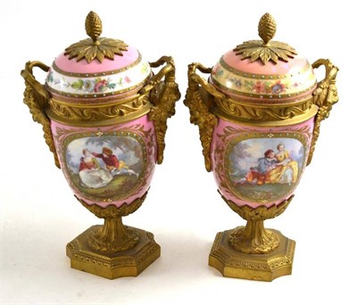 Lot 106 - A pair of French Sevres style gilt metal mounted vases, pink ground
