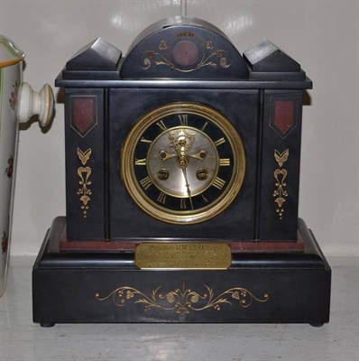 Lot 114 - A black slate and marble striking mantel clock with presentation plaque