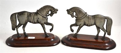 Lot 117 - A pair of cast metal and mahogany horse door stops