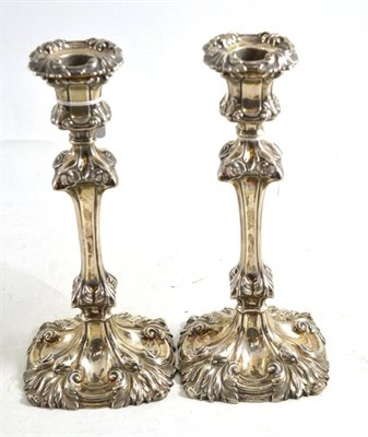 Lot 127 - A pair of silver Walker & Hall loaded candlesticks, Sheffield 1898 and 1896