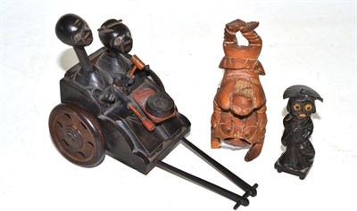 Lot 132 - A Japanese carved wooden pull along automata of a man and woman banging a drum and two other...