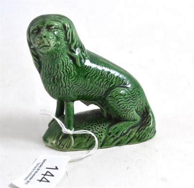 Lot 144 - A green glazed creamware dog