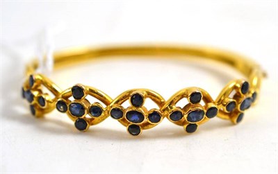 Lot 178 - An 18ct gold sapphire set bangle