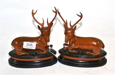 Lot 208 - Pair of carved wood recumbent deer