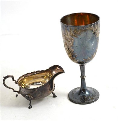 Lot 240 - Victorian silver goblet engraved with floral designs, Sheffield 1896 and a silver sauce boat (2)