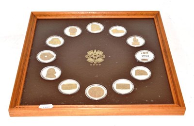 Lot 250 - Twelve sterling silver medallions celebrating the Aztec culture, in wooden frame