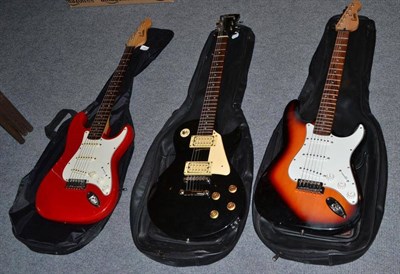 Lot 381 - Three Encore electric guitars, in soft cases