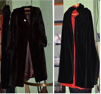 Lot 402 - Mourning coat and trousers, a fur coat and a cloak