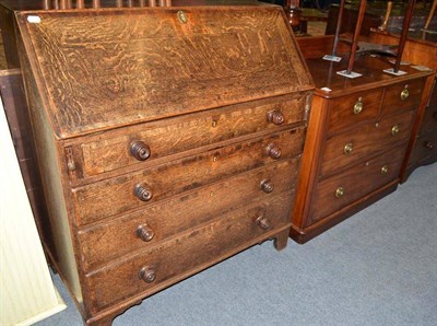 Lot 492 - A Victorian mahogany three height chest of drawers and an oak bureau