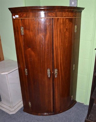 Lot 548 - George III mahogany bow fronted wall hanging corner cupboard