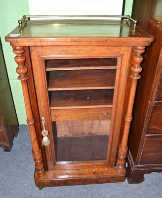 Lot 556 - A Victorian walnut music cabinet with glazed door and brass gallery