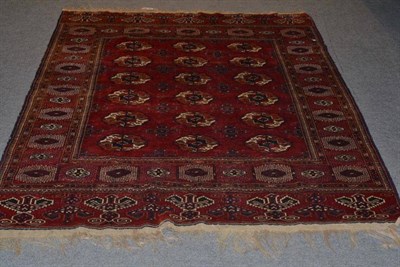 Lot 567 - An Afghan rug, North West Afghanistan, the madder field with three rows of quartered guls...