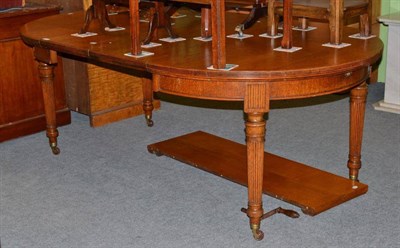 Lot 568 - Oak dining table and three leaves (with winder)