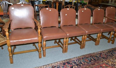 Lot 670 - A set of six oak framed dining chairs including two carvers