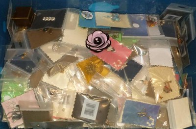 Lot 57 - A plastic box of costume jewellery, mainly vintage brooches