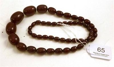 Lot 65 - A strand of amber beads, 67g gross (some loose beads)