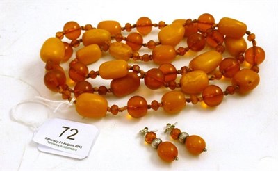 Lot 72 - An amber bead necklace, with yellowy orange barrels spaced by faceted and polished graduated...