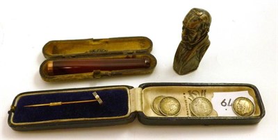 Lot 101 - A Gladstone vesta case, an amber pipe holder, a gold tie pin set with a pearl and four 3d coins