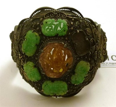 Lot 110 - A Chinese silver filigree bangle set with jade panels, one missing