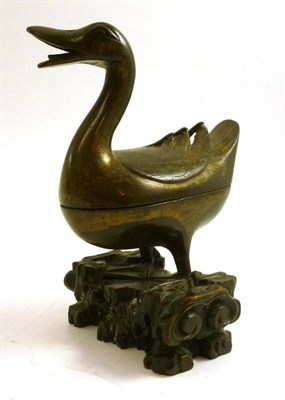 Lot 147 - A Chinese bronze casket modelled as a duck mounted on a wooden base with gilt highlights