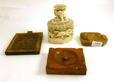 Lot 149 - A Mouseman ashtray, an African ivory tusk vase carved in high relief with game animals, circa 1930