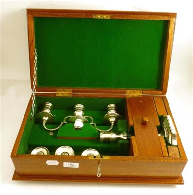 Lot 163 - A three branch silver loaded candlestick in a fitted case