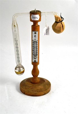 Lot 180 - A 19th century John Daniell type hygrometer, with beech stand, glass bulbs and thermometer...