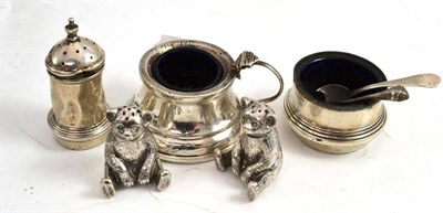 Lot 219 - Two silver teddy bear pepperettes, two silver salts and a silver pepperette (5)