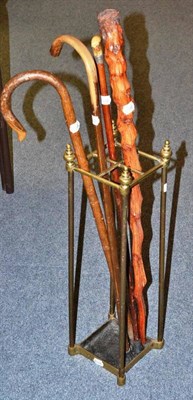 Lot 316 - Brass stick stand and four walking sticks