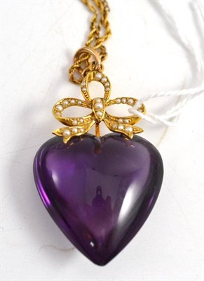 Lot 340 - A heart shaped cabochon amethyst coloured and split pearl set pendant on a rope twist chain