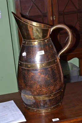 Lot 396 - A large brass bound jug