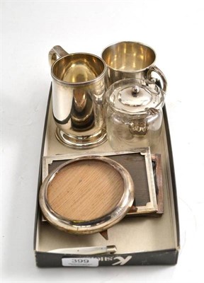 Lot 399 - A quantity of silver including two mugs, photo frames, fruit knives etc