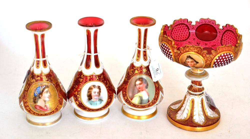 Lot 9 - Three Bohemian Ruby and White Overlay Glass Child Portrait Vases, circa 1870, each of pedestal...