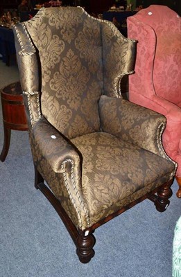 Lot 554 - An oak wing armchair